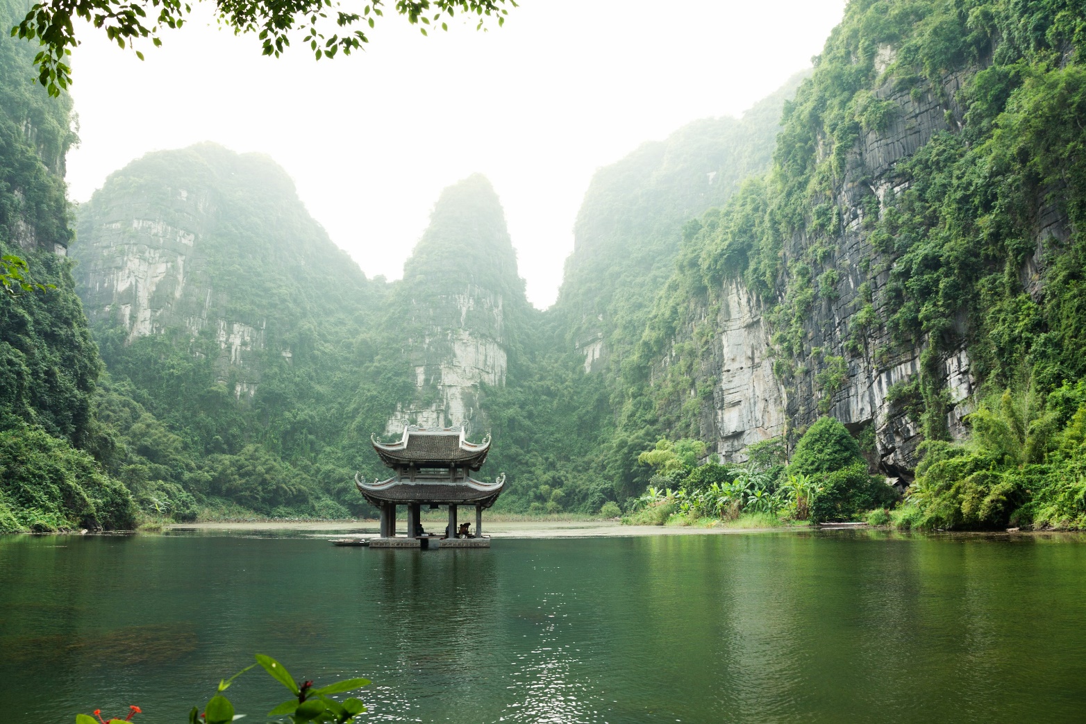 pagoda surrounded by body of water and mountains